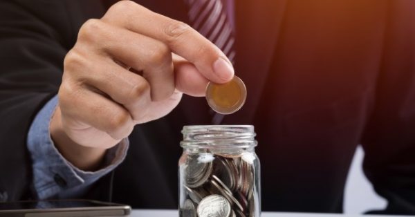 hand-putting-mix-coins-seed-clear-bottle-copyspace-business-investment-growth-concept_1423-104